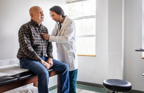 A man gets his pulse checked at a doctor's office