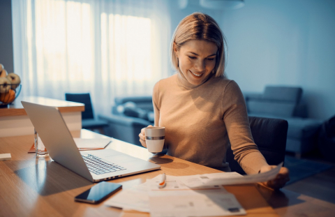 Woman reviews bank statements for credit card debt consolidation methods.