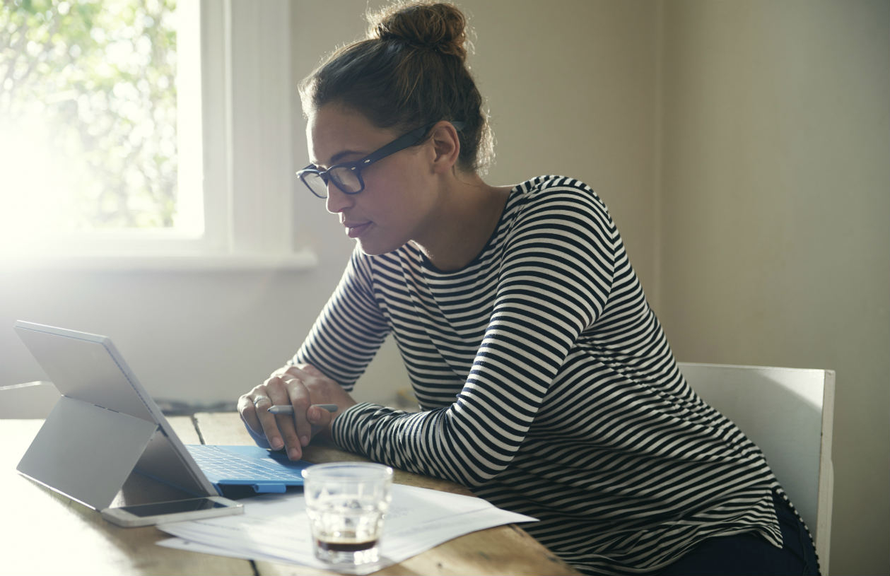 Woman using financial checklist to reach her personal finance goals