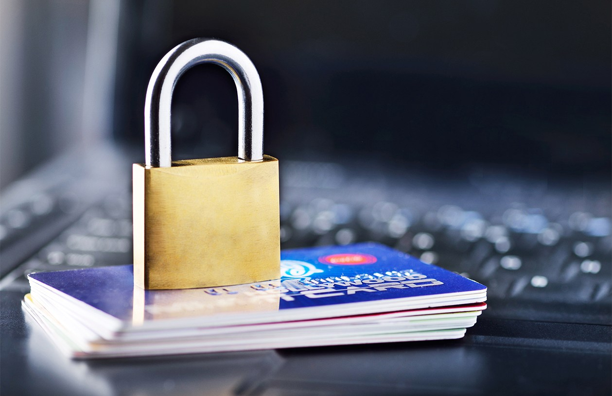 padlock sits on top of a stack of credit cards