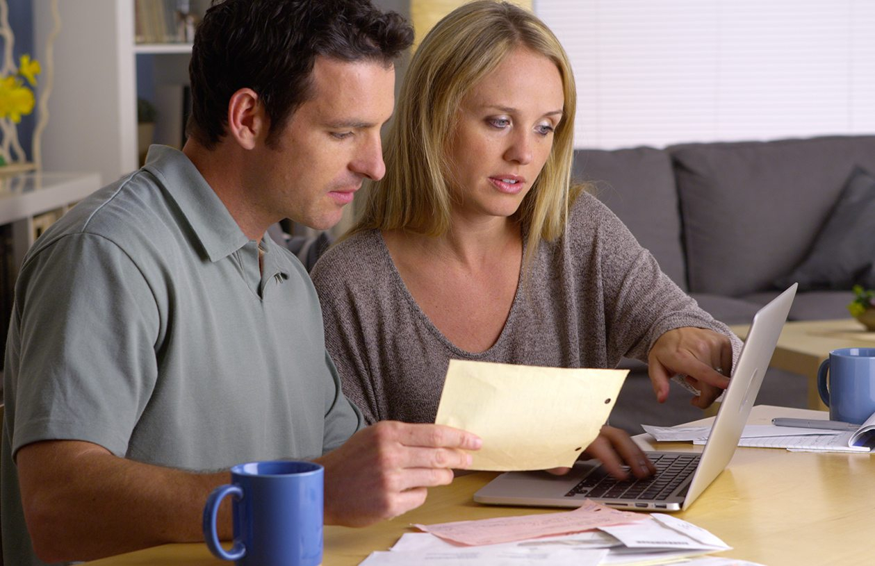 Man and woman looking at laptop considering a roth ira
