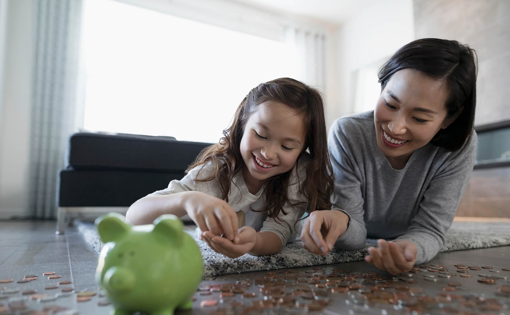 Kids savings accounts, mom and daughter learning to bank