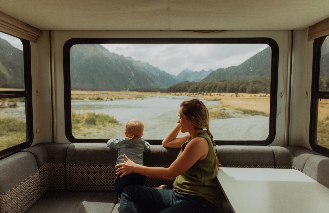 After getting an RV loan, a mother and child enjoy their recreational vehicle and camper.
